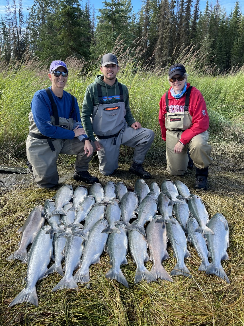 People proudly posing with the fish they have caught